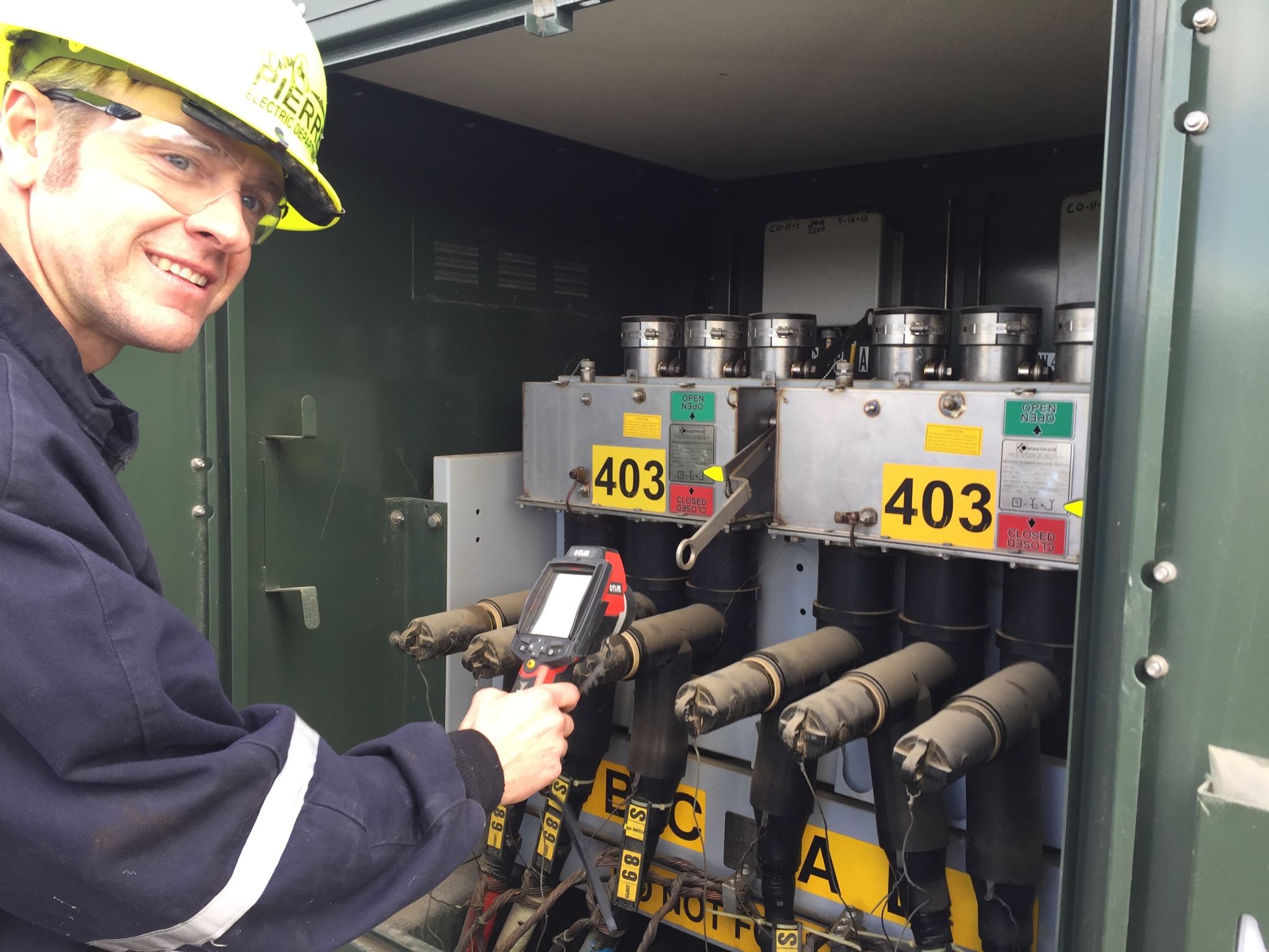 City Staff uses infrared heat gun to check electrical device